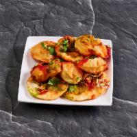 Sev Puri · Crispy round shells filled with potatoes, chickpeas, spices, yogurt, tamarind chutney, toppe...