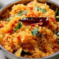 Tomato Rice · Rice made with tomato sauce, green chillies, curry leaves, cashews.