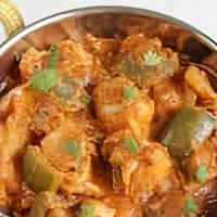 Kadai Paneer · Cubes of paneer cooked with ginger, garlics, onion, and tomatoes in a semi dry gravy.
