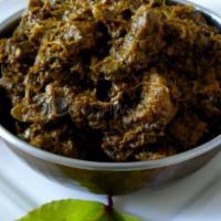 Gongura Goat Curry · Goat cooked with Indian spices and gongura leaves.