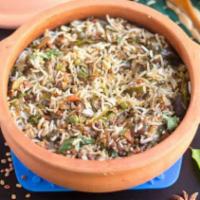 Ulavacharu Vegetable Dum Biryani · Basmati rice cooked with Indian herbs, ulavacharu, and vegetables.