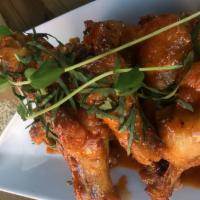 Wings · Confit chicken wings baked and pan-seared in a house-made general Tso sauce.

