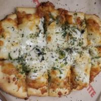 Cheesy Garlic Bread · Out signature crust topped with roasted garlic, five italian cheese blend fresh thyme, rosem...