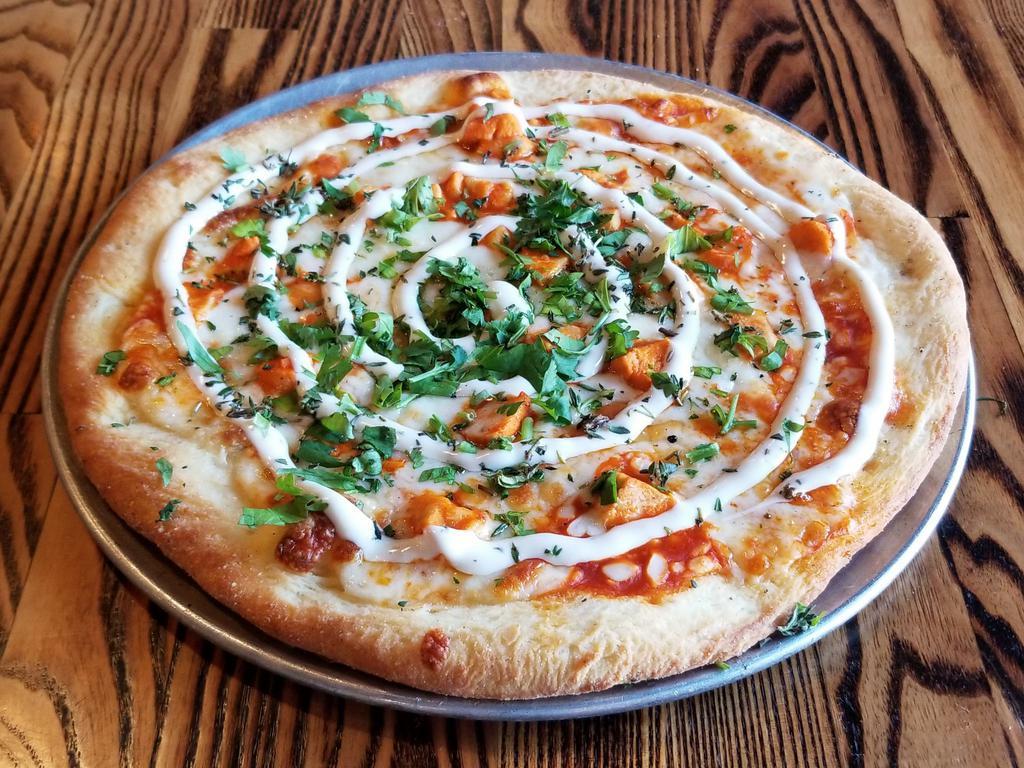 BUFFALO CHICKEN · Buffalo sauce, creamy white sauce, buffalo chicken breast, mozzarella, provolone, top with fresh parsley, thyme and ranch dressing after cooking.