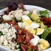 Cobb Salad · Crisp romaine, fresh avocado, grilled chicken breast, smoked bacon, egg, tomatoes, gorgonzol...