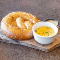 Soft Bavarian Pretzel · Baked fresh in house daily served with beer cheese dip and mustard sauce. Vegetarian.