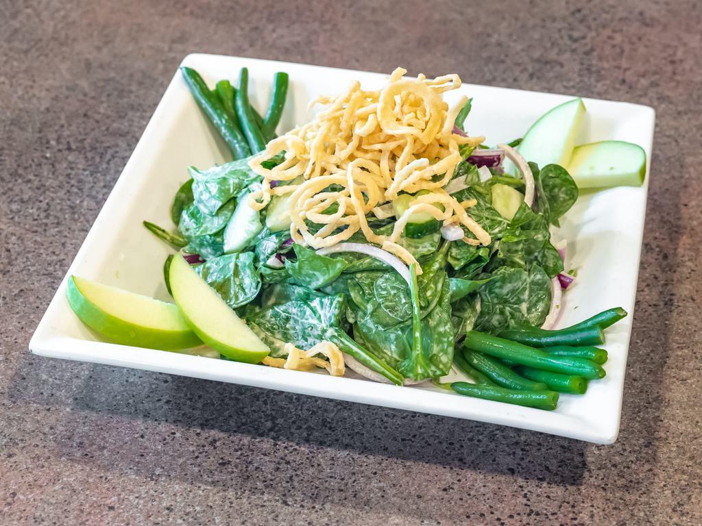 Green on Greens Salad · Herbaceous green goddess dressing tossed with fresh baby spinach, cucumber, red onion, green apple, green beans, and crispy onions. Vegetarian.