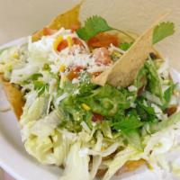 Mario's Tostada Salad · Served on a crispy flour tortilla. Topped with lettuce tomatoes, cheese, guacamole, sour cre...