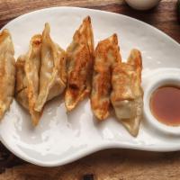 Gyoza · Pan-seared pork dumplings with special sauce.