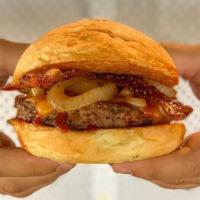 Chipotle BBQ Burger · Grilled onions, smokehouse bacon, cheddar and chipotle BBQ sauce.