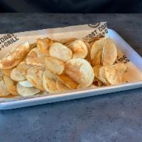 Basket of Freshly Sliced Potato Chips · Sliced daily, cooked to a golden crisp, and then seasoned with our East Coast Wings and Gril...