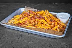 Loaded Fries · Melted nacho cheese and bacon bits.