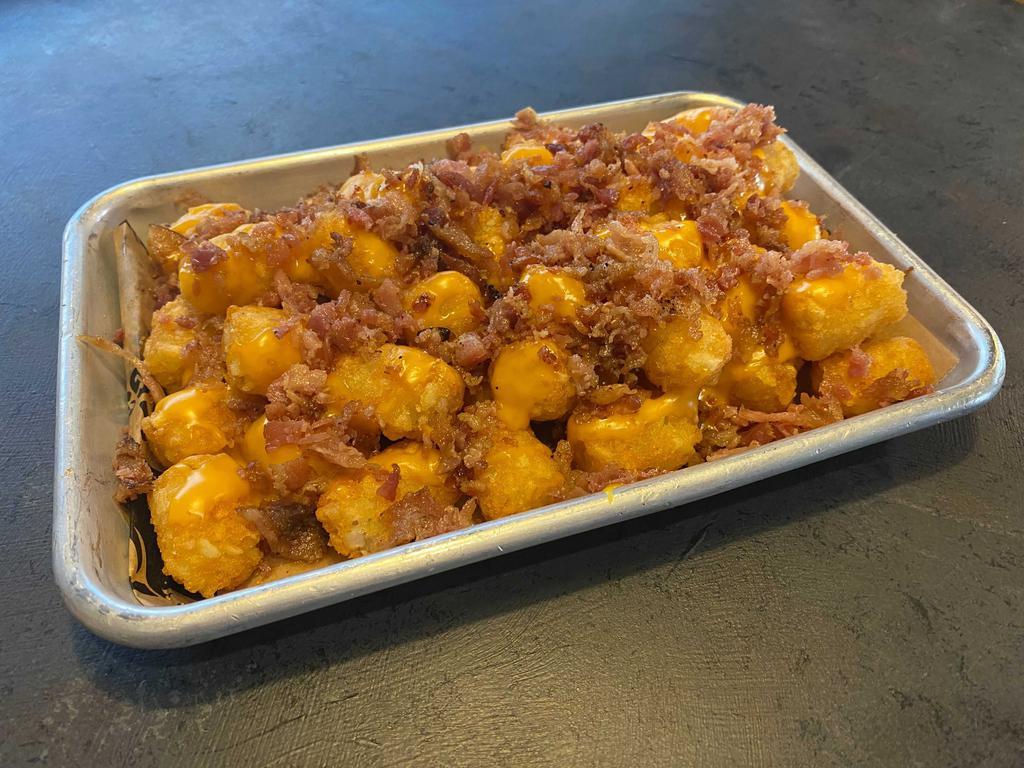 Loaded Tots · Crispy tater tots loaded with nacho cheese and bacon.