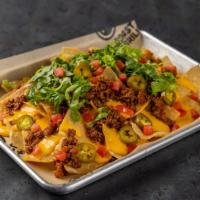 Classic Nachos · A generous portion of tortilla chips smothered with seasoned Angus ground beef, melted chedd...