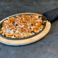 Gravy Fries · A heaping portion of crispy ale-battered French fries topped with our special gravy and mozz...