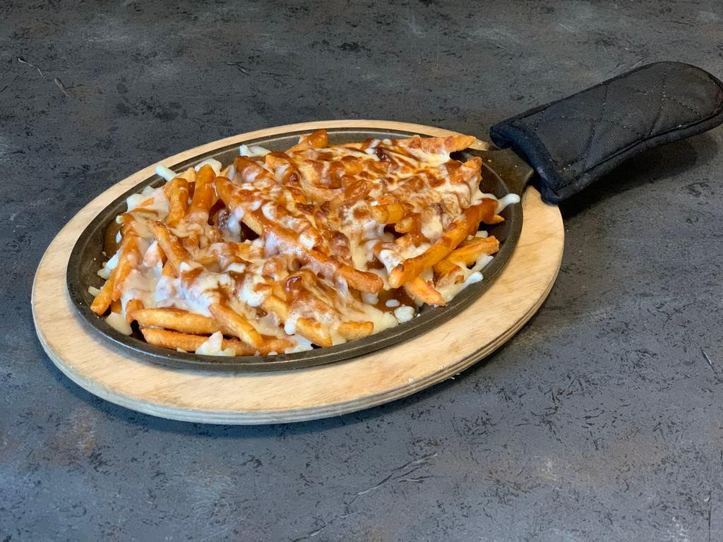 Gravy Fries · A heaping portion of crispy ale-battered French fries topped with our special gravy and mozzarella cheese browned to perfection on a skillet.