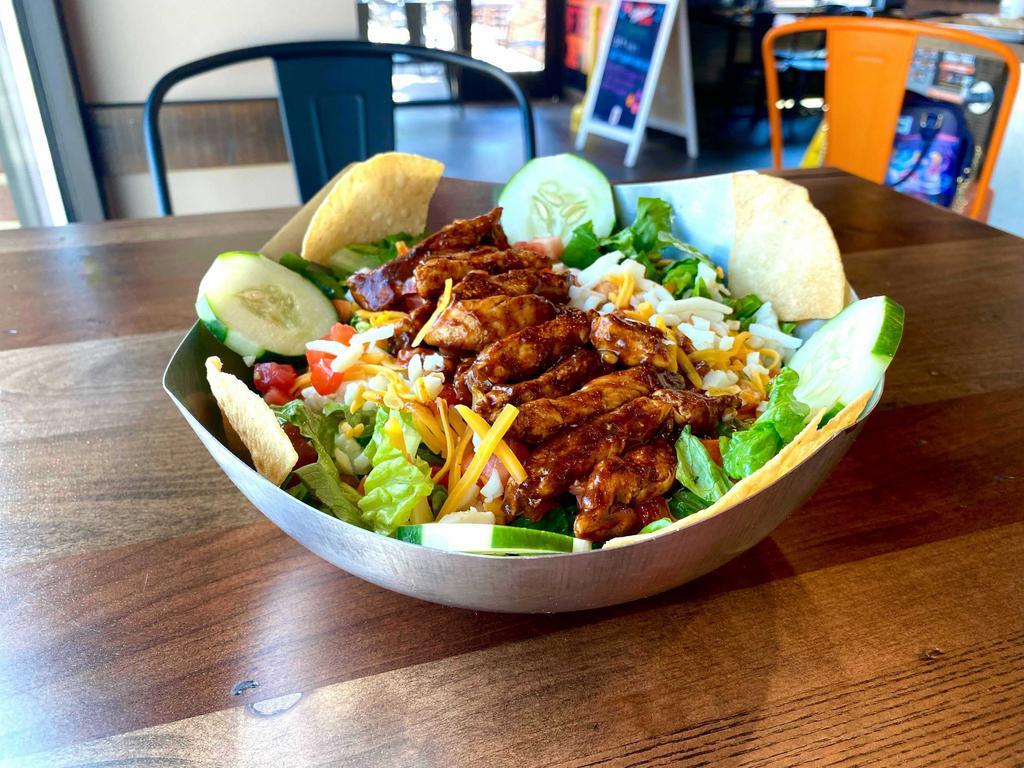 NEW! Southwestern Chicken Salad · Chipotle glazed grilled chicken on a bed of freshly chopped romaine lettuce, diced tomatoes, aged shredded cheddar and mozzarella cheeses, sliced cucumbers, and drizzled with our ECW+G Signature Lava Ranch®. Topped with lightly seasoned tortilla chips.