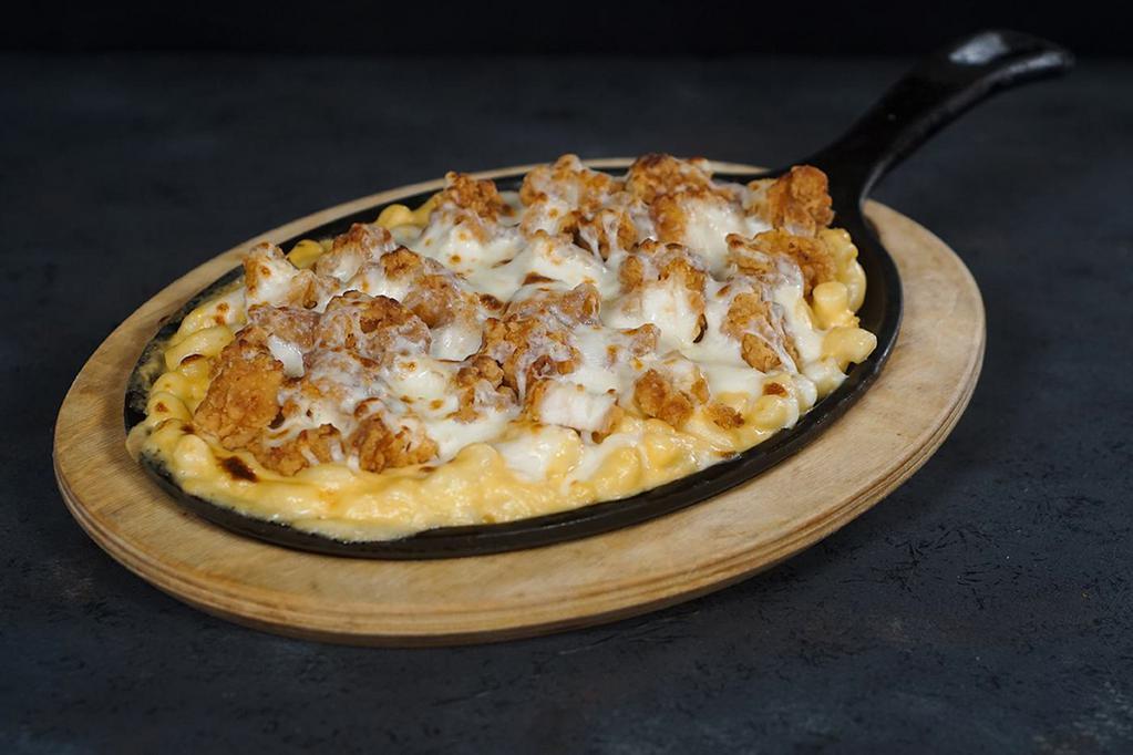 Chicken Mac and Cheese Skillet · Our signature mac and cheese mixed with crispy chunks of chicken breast then topped with Mozzarella and Parmesan cheeses and browned to perfection on a skillet.