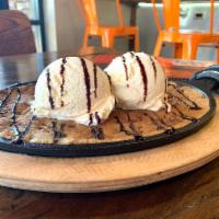 The Original Cookie Skillet · Chocolate chip cookies baked fresh on a skillet and topped with vanilla ice cream and drizzl...