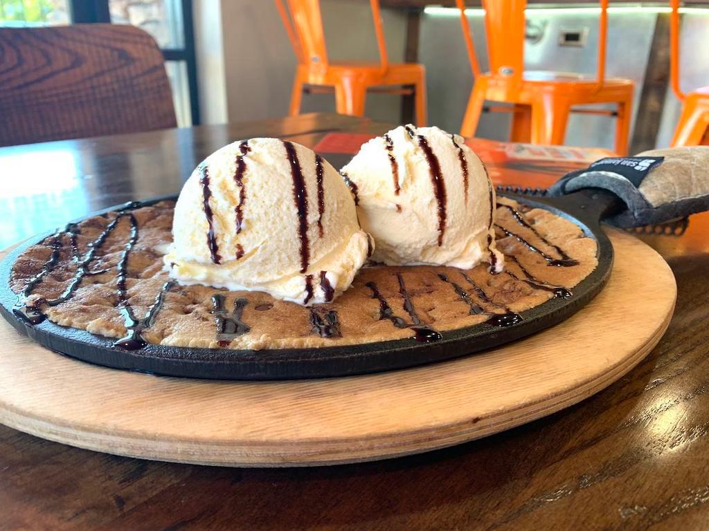 The Original Cookie Skillet · Chocolate chip cookies baked fresh on a skillet and topped with vanilla ice cream and drizzled with chocolate sauce.