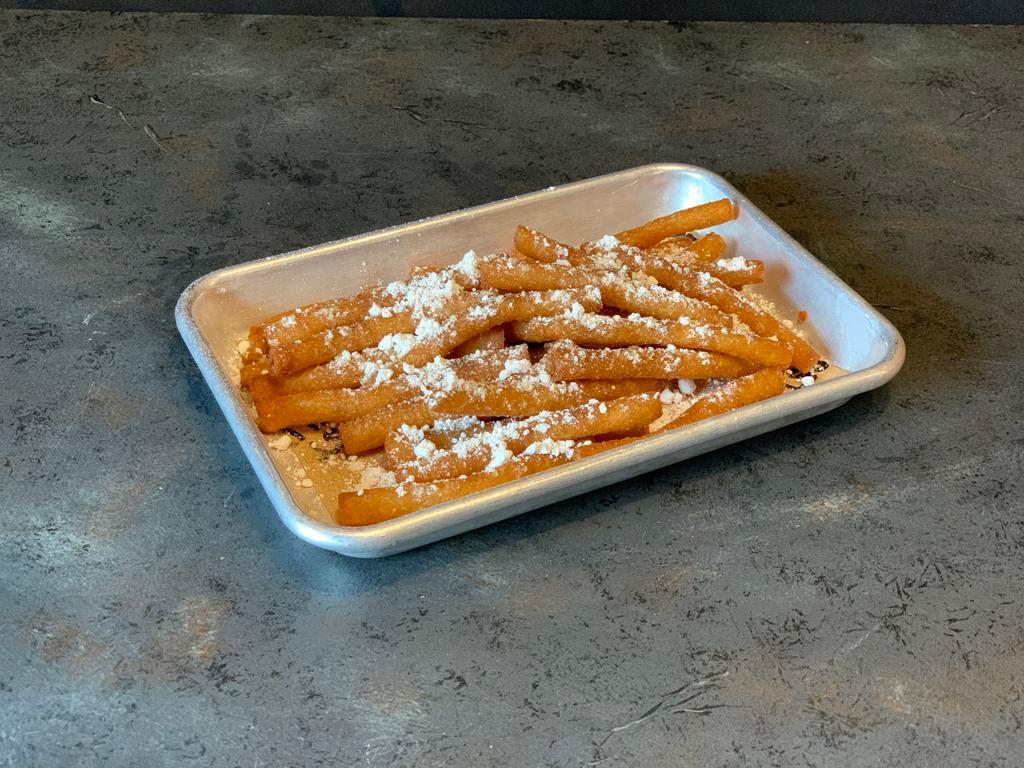Carnival Fries · Tasty funnel cake sticks sprinkled with cinnamon and powdered sugar, served with your choice of raspberry, caramel or chocolate dipping sauce.