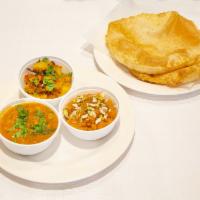 8. Chhole Puri Breakfast · Punjabi puri or bhatura with halwa.