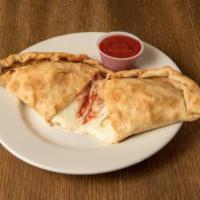 Calzone · A pocket of pizza dough stuffed with mozzarella cheese and pizza sauce. Toasted in our oven.