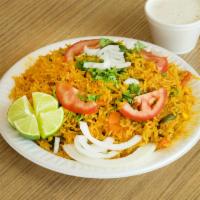 Vegetable Biryani · Cooked with basmati rice, nuts, raisins and spices. Served with raita.