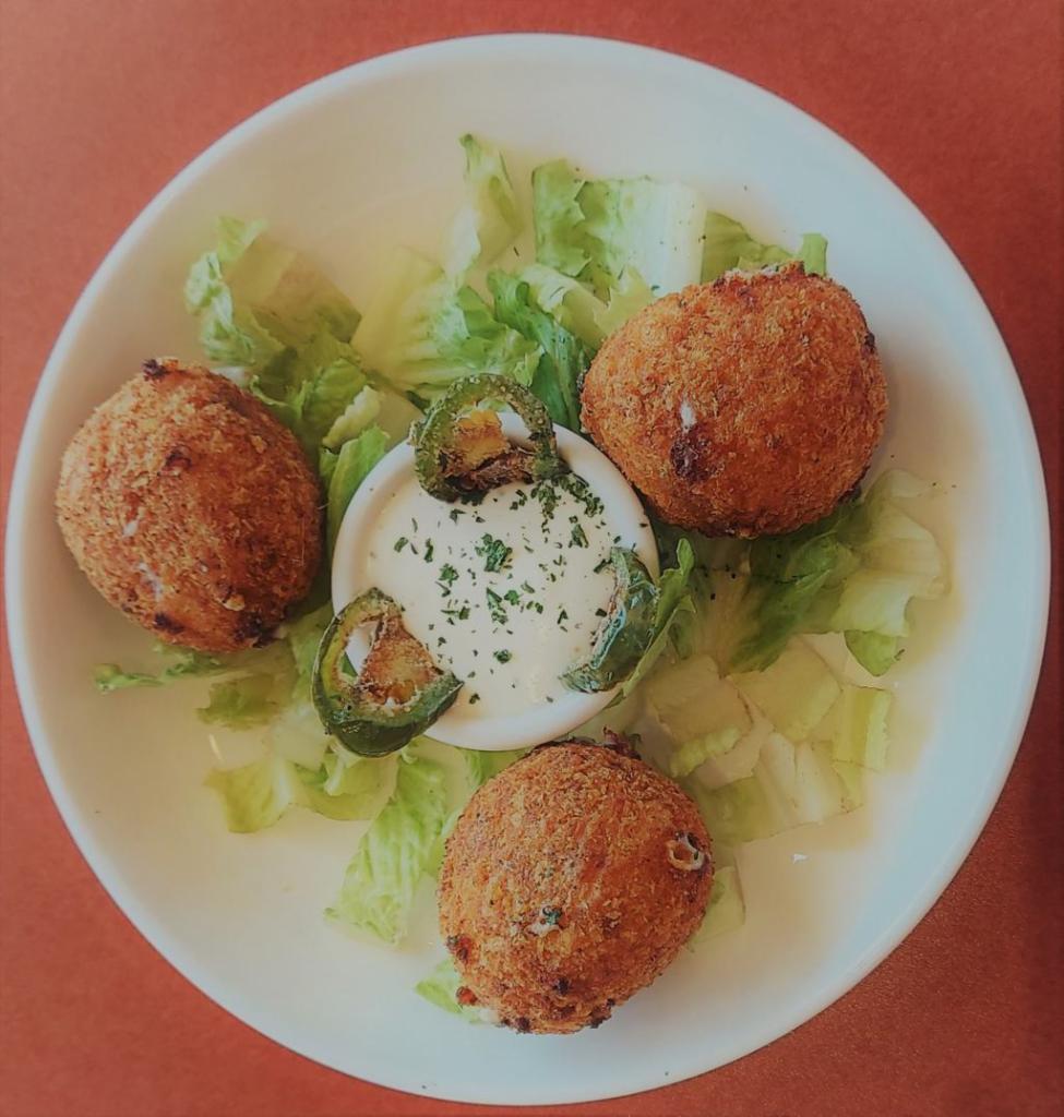 Jalapeño Poppers · Fried balls stufed with three cheese belnd, cream cheese and grilled Jalapeño served with in-house Jalapeño cilantro infused sauce.