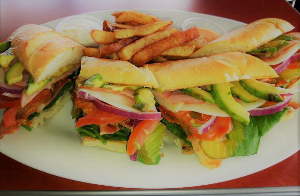 Oxaca Veggie Sandwich  · Served with roasted veggies, lettuce, tomatoes, red onion, avocado, fresh mozzarella cheese, spinach and signature sauce.
