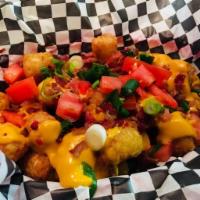 Irish Nachos · Tater tots with queso cheese and bacon bits, topped with tomato, green onion and sour cream....