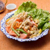 Green Papaya Salad (Som-Tum) · Shredded green papaya, green bean, tomato and peanuts in spicy lime dressing. Served with le...