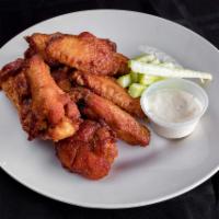 Wings · Cooked with our own secret spice rub. Served mild, hot or BBQ.