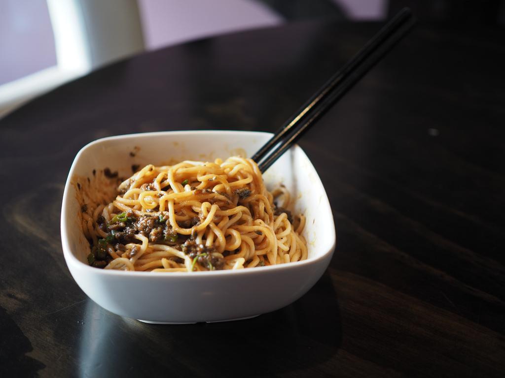 Jane's Dan Dan Noodles · Shanghai egg noodles, light soy sauce and topped with minced beef. Spicy. Contains peanut sauce.