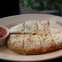 Cheesy Garlic Bread · Garlic bread made with Connie's signature dough topped with melted mozzarella. Served with m...