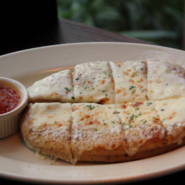 Cheesy Garlic Bread · Garlic bread made with Connie's signature dough topped with melted mozzarella. Served with marinara sauce. Vegetarian.