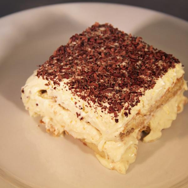 Tiramisu · Handmade layers of coffee-soaked sponge cake and creamy mascarpone dusted with grated chocolate.