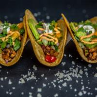 Vegan Tacos · Organic corn tortilla filled with sautéed mushroom, bell pepper, onion. Topped
with romaine ...