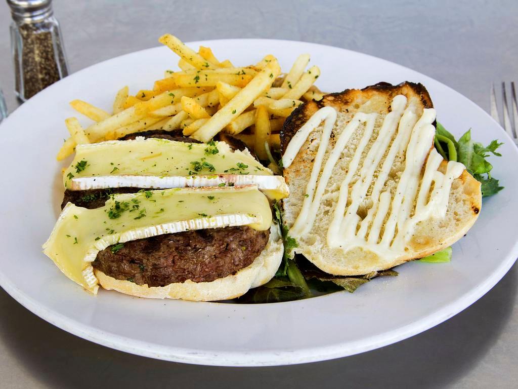 100% Angus beef Burger · Served with tomato, caramelized onions, aioli, ciabatta roll, with french fries or salad.