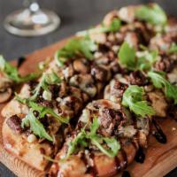 Black and Blue Flatbread · Blackened steak, caramelized onions & mushrooms, mozzarella & blue cheeses, finished with fr...