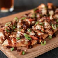 Chipotle BBQ Chicken Flatbread · Tender, grilled chicken with onions, peppers & bacon smothered in mozzarella cheese. Finishe...