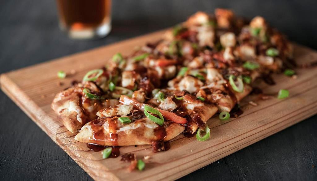 Chipotle BBQ Chicken Flatbread · Tender, grilled chicken with onions, peppers & bacon smothered in mozzarella cheese. Finished with a drizzle of chipotle BBQ.