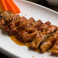 D4. Duck Tamriand · Boneless duck served with homemade tamarind sauce and steamed vegetable top with fried garlic