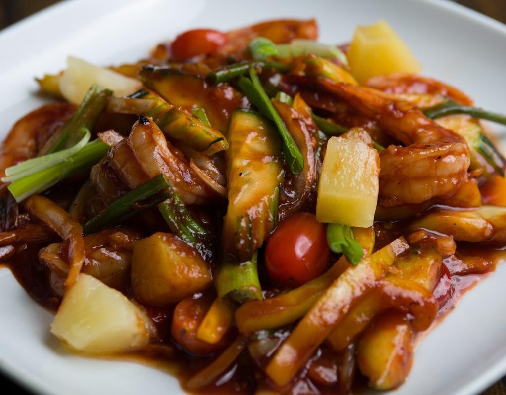 B4. Sweet and Sour · Sauteed with garlic, pineapple, tomatoes, cucumber, scallions, onions, and bell pepper in homemade sweet and sour sauce.
