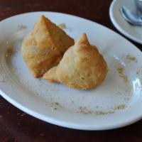 2 Pieces Vegetable Samosas · Triangular puffed pastry stuffed with cubed potatoes, green peas, carrots and mildly spiced ...