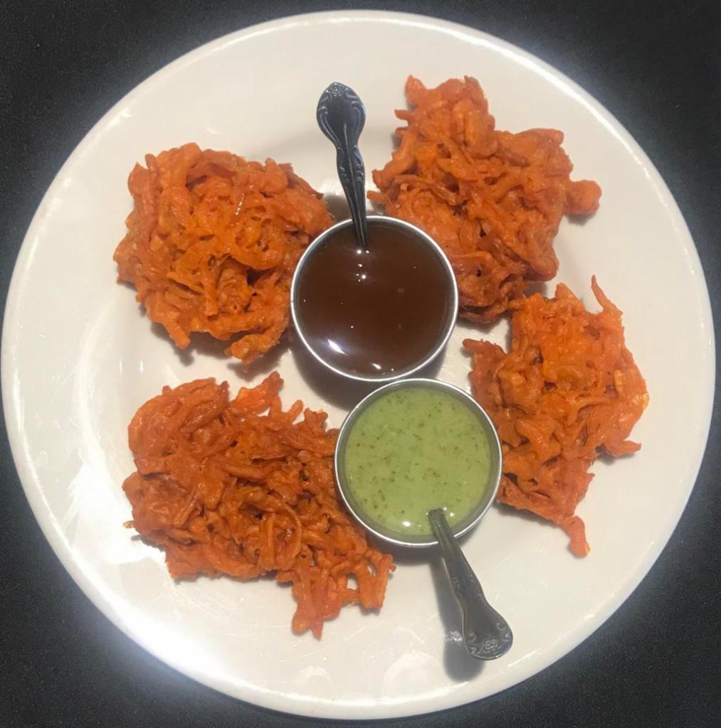 4 Pieces Onion Pakora · Freshly sliced onion fritters with chickpea flour, whole coriander, black cumin and other herbs.