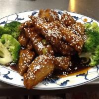 Sesame Chicken · Large chunks of crispy chicken, sauteed with rich brown sauce topped with sesame and served ...