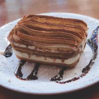 Tiramisu · An Italian dessert made with mascarpone, espresso-soaked ladyfingers, whipped cream and a da...
