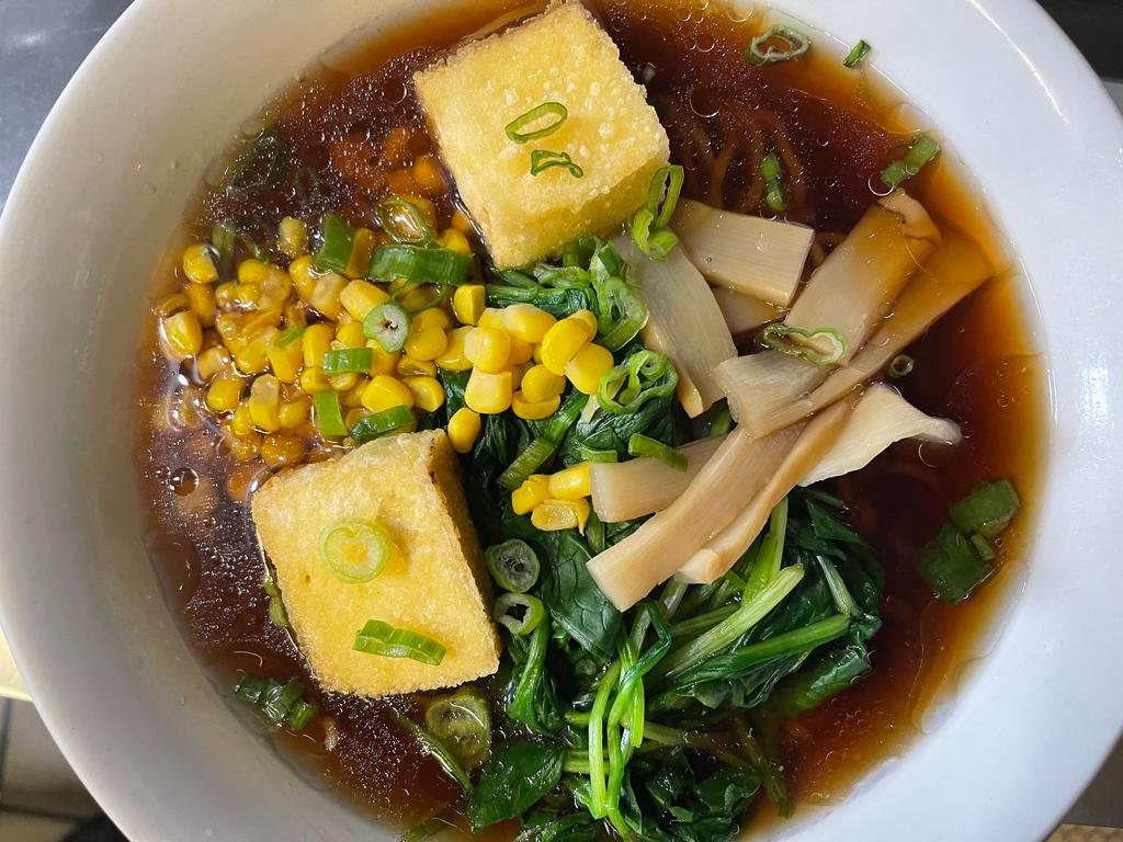 V1. Buddha Ramen · Shoyu (soy sauce) based vegetable broth topped with boiled spinach, bean sprouts, corn, aged tofu, bamboo shoots and scallions.