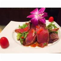 Spicy Tuna Tataki · Seared tuna with red pepper mix served with radish, onion and ponzu sauce. 